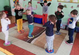dzieci podczas zabawy z małymi obręczami plastikowymi "Ptaszki do gniazd"