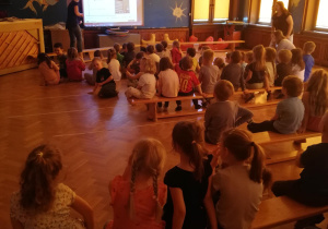 dzieci oglądają film o pszczołach na tablicy multimedialnej