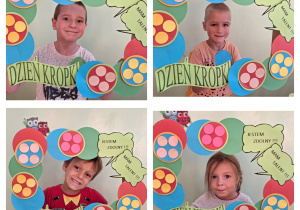 Dzieci pozują do zdjęcia w kropkowej fotobudce.