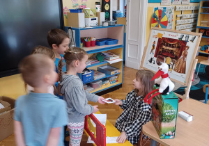 dzieci kupują w kasie zrobionej z ławeczki na niby bilety do teatrzyku " Bajkowa kawiarenka"
