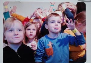 Na zdjęciu dzieci i nauczycielka pozują do zdjęcia w fotobudce.