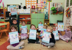 Dzieci pookazują pokolorowane przez siebie obrazki z wybranym prawem dziecka