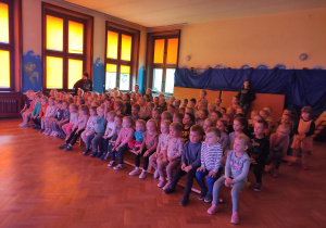 przedszkolaki z wszystkich grup siedzący na widowni podczas przedstawienia
