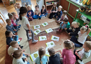 Dzieci na zdjęciu oglądają ilustrację drzew.
