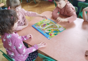 przedszkolaki grające w grę planszową