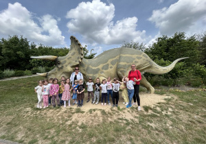 dzieci z grupy pszczółek z Paniami na tle dinozaura